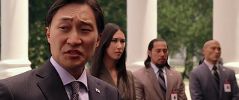 Movie still from “Olympus Has Fallen” (2013), directed by Antoine Fuqua – A group of people standing next to each other wearing suits and ties; Close Up shot, Over the shoulder angle