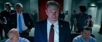 Movie still from “Olympus Has Fallen” (2013), directed by Antoine Fuqua – A person wearing a suit and tie; Medium shot, Low angle