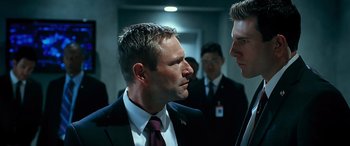 Movie still from “Olympus Has Fallen” (2013), directed by Antoine Fuqua – A man in a suit and tie talking to another man in a suit and tie; Close Up shot, Over the shoulder angle