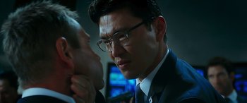 Movie still from “Olympus Has Fallen” (2013), directed by Antoine Fuqua – A person wearing a suit and glasses; Close Up shot, Over the shoulder angle