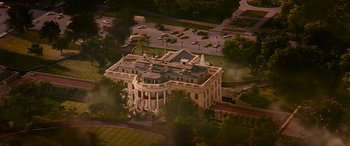 Movie still from “Olympus Has Fallen” (2013), directed by Antoine Fuqua – An aerial view of a large white building with cars parked in front of it; Extreme Wide shot, High angle