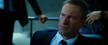 Movie still from “Olympus Has Fallen” (2013), directed by Antoine Fuqua – A person wearing a suit and tie; Close Up shot, Over the shoulder angle