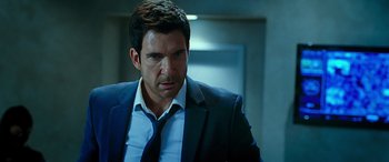 Movie still from “Olympus Has Fallen” (2013), directed by Antoine Fuqua – A person wearing a suit and tie; Close Up shot, Over the shoulder angle