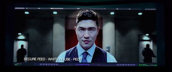 Movie still from “Olympus Has Fallen” (2013), directed by Antoine Fuqua – A man in a suit and tie on a television screen; Close Up shot, Low angle