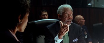 Movie still from “Olympus Has Fallen” (2013), directed by Antoine Fuqua – An older man in a suit and tie talking; Close Up shot, Low angle
