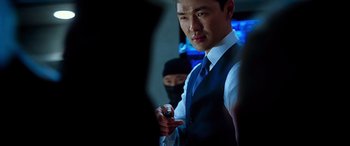 Movie still from “Olympus Has Fallen” (2013), directed by Antoine Fuqua – A man wearing a suit and tie holding a cell phone; Close Up shot, Over the shoulder angle