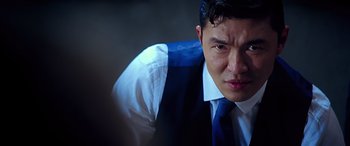 Movie still from “Olympus Has Fallen” (2013), directed by Antoine Fuqua – A person wearing a vest and a tie; Close Up shot, Over the shoulder angle