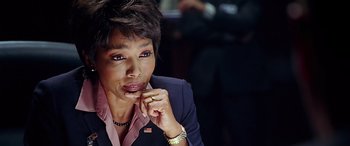 Movie still from “Olympus Has Fallen” (2013), directed by Antoine Fuqua – A person wearing a suit and tie; Close Up shot, Over the shoulder angle