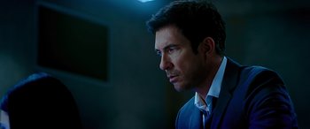 Movie still from “Olympus Has Fallen” (2013), directed by Antoine Fuqua – A man in a suit and tie looking to his left; Close Up shot, Over the shoulder angle