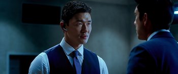 Movie still from “Olympus Has Fallen” (2013), directed by Antoine Fuqua – A man in a blue vest and a blue tie; Close Up shot, Over the shoulder angle