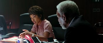 Movie still from “Olympus Has Fallen” (2013), directed by Antoine Fuqua – Two people sitting at a table with a laptop; Medium shot, Over the shoulder angle