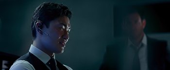 Movie still from “Olympus Has Fallen” (2013), directed by Antoine Fuqua – A man in a suit and tie looking to his left; Close Up shot, Low angle