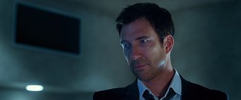 Movie still from “Olympus Has Fallen” (2013), directed by Antoine Fuqua – A person wearing a suit and tie; Close Up shot, Low angle