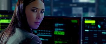 Movie still from “Olympus Has Fallen” (2013), directed by Antoine Fuqua – A woman in front of computer screens in a dark room; Close Up shot, Over the shoulder angle