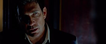 Movie still from “Olympus Has Fallen” (2013), directed by Antoine Fuqua – A person wearing a suit and tie; Close Up shot, Low angle