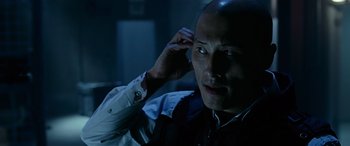 Movie still from “Olympus Has Fallen” (2013), directed by Antoine Fuqua – A person holding his hand up to his head; Close Up shot, Low angle