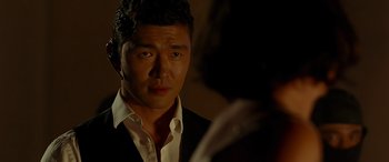 Movie still from “Olympus Has Fallen” (2013), directed by Antoine Fuqua – A person wearing a suit and tie; Close Up shot, Over the shoulder angle