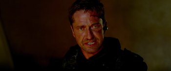 Movie still from “Olympus Has Fallen” (2013), directed by Antoine Fuqua – A person with a bandage on his head; Close Up shot, Low angle