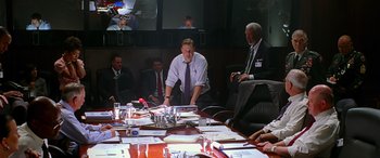 Movie still from “Olympus Has Fallen” (2013), directed by Antoine Fuqua – A group of people sitting around a table; Wide shot, Over the shoulder angle