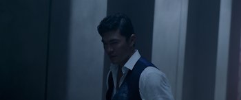 Movie still from “Olympus Has Fallen” (2013), directed by Antoine Fuqua – A man wearing a vest standing next to a wall; Medium shot, Low angle