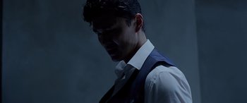 Movie still from “Olympus Has Fallen” (2013), directed by Antoine Fuqua – A man wearing a white shirt and a blue vest; Close Up shot, Low angle