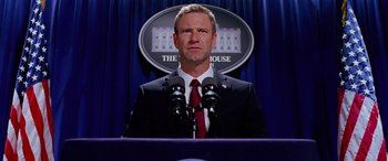 Movie still from “Olympus Has Fallen” (2013), directed by Antoine Fuqua – A man standing at a podium in front of the white house; Close Up shot, Low angle