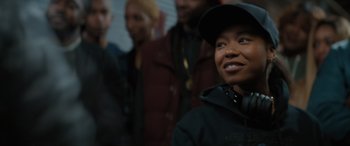 Movie still from “On the Come Up” (2022), directed by Sanaa Lathan – A group of people standing next to each other in a room; Close Up shot, Over the shoulder angle