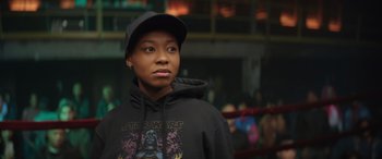 Movie still from “On the Come Up” (2022), directed by Sanaa Lathan – A person wearing a hat and a sweatshirt; Close Up shot, Over the shoulder angle