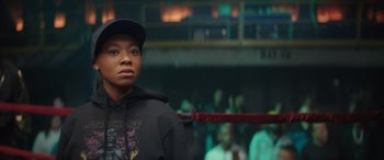 Movie still from “On the Come Up” (2022), directed by Sanaa Lathan – A man standing in a boxing ring wearing a hat; Close Up shot, Over the shoulder angle