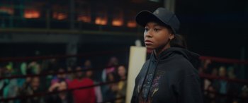 Movie still from “On the Come Up” (2022), directed by Sanaa Lathan – A woman in a black hat and a black hoodie; Medium shot, Over the shoulder angle