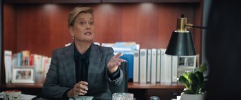 Movie still from “On the Come Up” (2022), directed by Sanaa Lathan – A woman in a suit is sitting at a desk; Medium shot, Over the shoulder angle