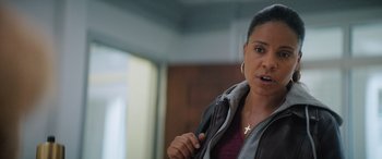 Movie still from “On the Come Up” (2022), directed by Sanaa Lathan – A woman with a cross on her chest talking to someone; Close Up shot, Over the shoulder angle