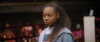 Movie still from “On the Come Up” (2022), directed by Sanaa Lathan – A young woman with long black hair is looking to her left; Close Up shot, Over the shoulder angle