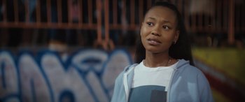 Movie still from “On the Come Up” (2022), directed by Sanaa Lathan – A woman standing in front of a wall with graffiti on it; Close Up shot, Over the shoulder angle
