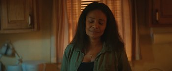 Movie still from “On the Come Up” (2022), directed by Sanaa Lathan – A woman with her eyes closed with a cross in her mouth; Close Up shot, Over the shoulder angle