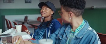 Movie still from “On the Come Up” (2022), directed by Sanaa Lathan – Two young women sitting at a table in front of drinks; Close Up shot, Over the shoulder angle