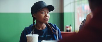 Movie still from “On the Come Up” (2022), directed by Sanaa Lathan – A woman sitting at a table with a cup of coffee in front of her; Close Up shot, Over the shoulder angle