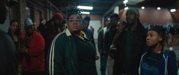 Movie still from “On the Come Up” (2022), directed by Sanaa Lathan – A group of people standing in a hallway; Medium shot, Low angle