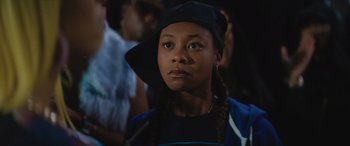 Movie still from “On the Come Up” (2022), directed by Sanaa Lathan – A young girl wearing a black hat and a blue shirt; Close Up shot, Low angle