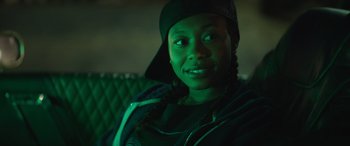 Movie still from “On the Come Up” (2022), directed by Sanaa Lathan – A woman sitting on top of a couch in a dark room; Close Up shot, Over the shoulder angle