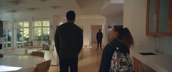 Movie still from “On the Come Up” (2022), directed by Sanaa Lathan – A man and a woman standing in a room with skateboards; Wide shot, Over the shoulder angle