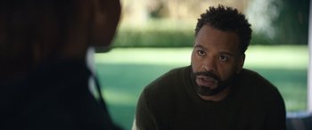 Movie still from “On the Come Up” (2022), directed by Sanaa Lathan – A man sitting in front of another man in front of a window; Close Up shot, Over the shoulder angle