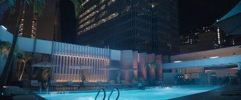 Movie still from “On the Come Up” (2022), directed by Sanaa Lathan – A swimming pool in front of a building at night; Extreme Wide shot, Low angle