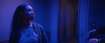 Movie still from “On the Come Up” (2022), directed by Sanaa Lathan – A person standing in a room with a blue light; Close Up shot, Over the shoulder angle