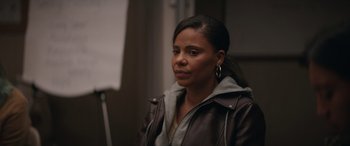 Movie still from “On the Come Up” (2022), directed by Sanaa Lathan – A woman in a brown jacket looking to her left; Close Up shot, Over the shoulder angle