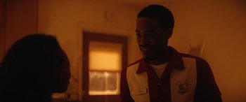 Movie still from “On the Come Up” (2022), directed by Sanaa Lathan – A man in a red and white shirt smiling; Close Up shot, Over the shoulder angle