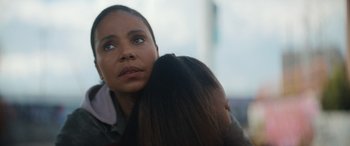 Movie still from “On the Come Up” (2022), directed by Sanaa Lathan – A woman is hugging another woman with her eyes closed; Close Up shot, Over the shoulder angle