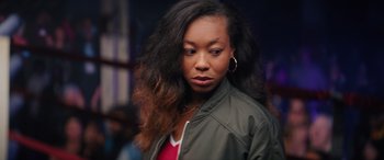 Movie still from “On the Come Up” (2022), directed by Sanaa Lathan – A young woman with long black curly hair; Close Up shot, Over the shoulder angle