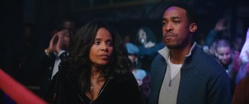 Movie still from “On the Come Up” (2022), directed by Sanaa Lathan – A woman standing next to a man in front of an audience; Close Up shot, Over the shoulder angle