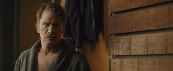 Movie still from “One Ranger” (2023), directed by Jesse V. Johnson – A person wearing a robe; Close Up shot, Over the shoulder angle